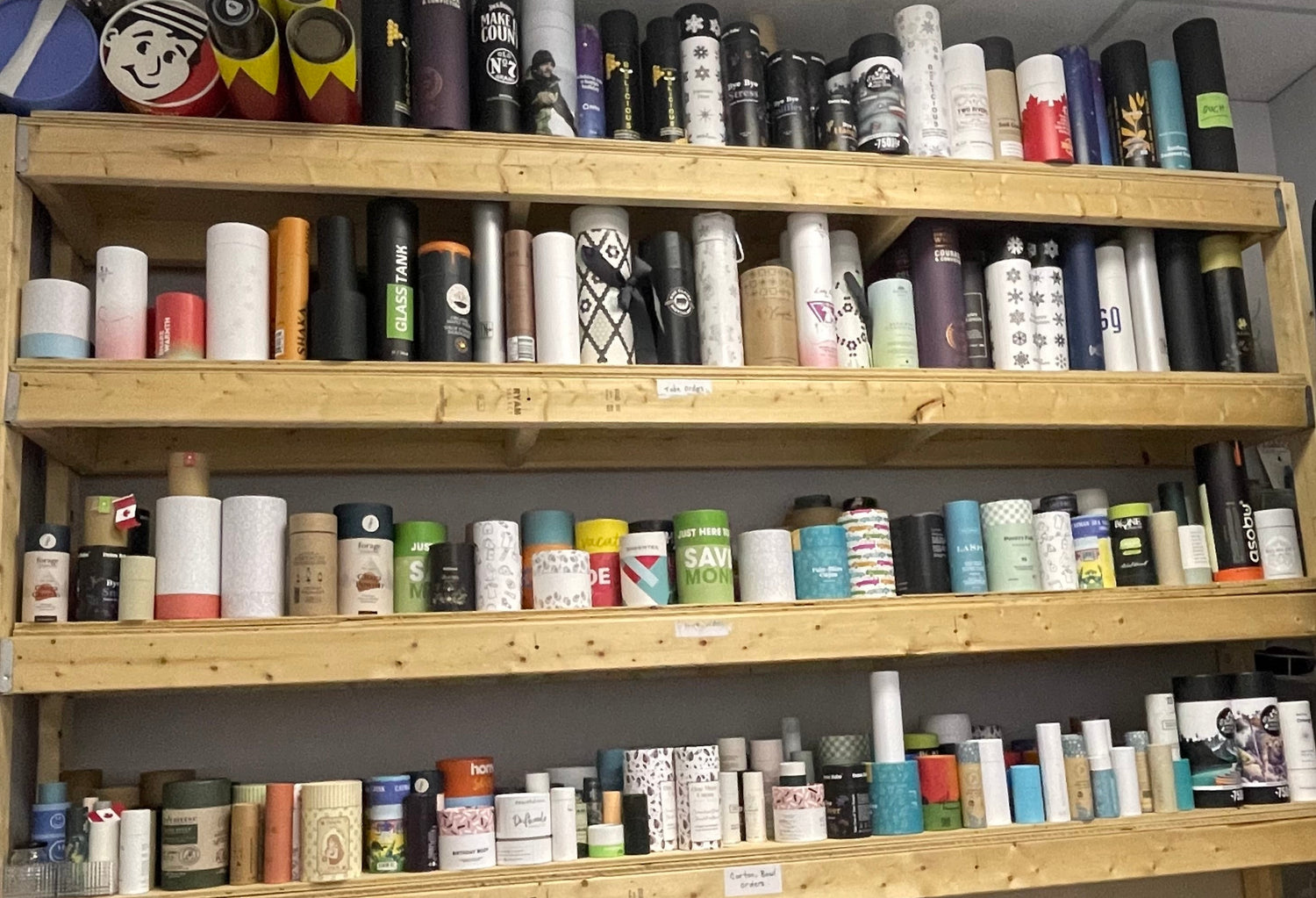 Shelves filled with various colorful cylindrical products in a store setting