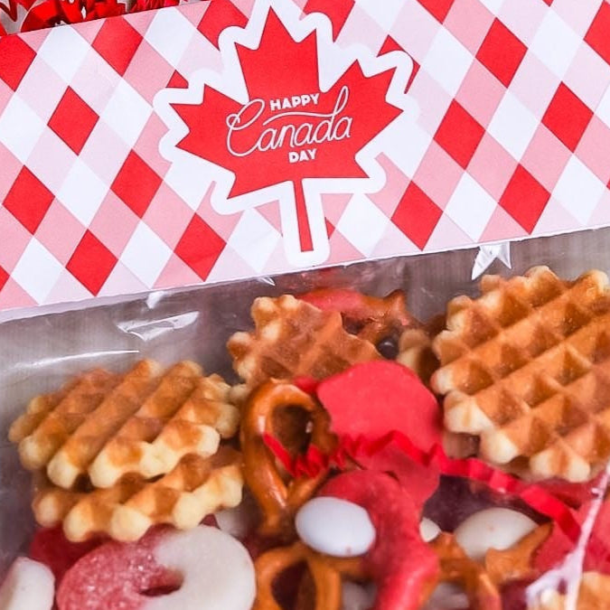 Packaged snack mix with a red and white checkered bag on a wooden surface.